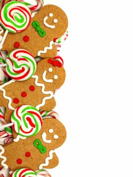 Christmas border of colorful gingerbread men and candies