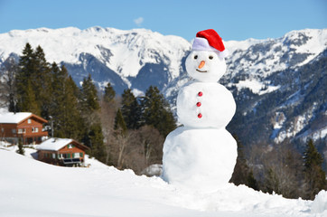 Snowman against Alpine panorama