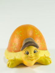 Decorative yellow tortoise ceramic with brown hat