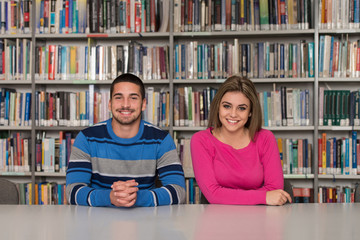 Couple Of Students In A Library