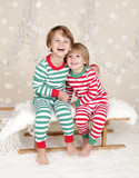Winter Holidays: Laughing Happy Kids in Christmas Pajamas Sled i