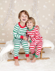 Winter Holidays: Laughing Happy Kids in Christmas Pajamas Sled i