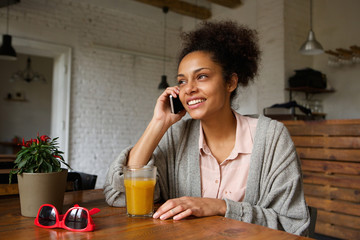 Young woman smiling and talking on mobile phone
