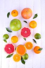 Juice and many citrus on table close-up