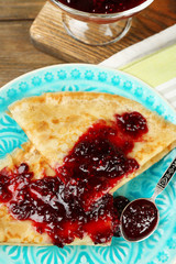 Plate of delicious pancakes with berry jam