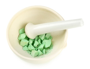 Laboratory pestle in mortar with ground material, isolated