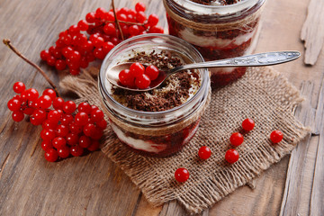 Delicious dessert in jars on table close-up