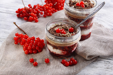 Delicious dessert in jars on table close-up