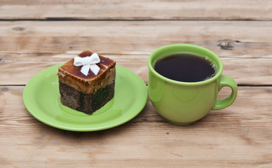 tea cup with colorful cookies, and  brown muffin on table