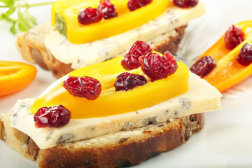 Sandwich with mold cheese, sweet peppers and cranberries on whit
