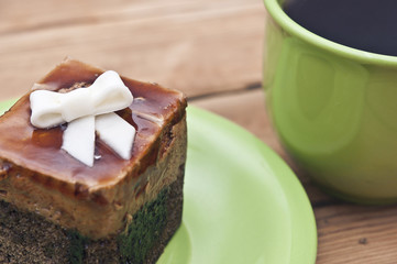 tea cup with colorful cookies, and  brown muffin on table