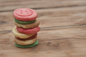 Multicolored sugar cookies on wooden background