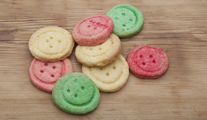 Multicolored sugar cookies on wooden background