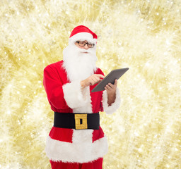 man in costume of santa claus with tablet pc