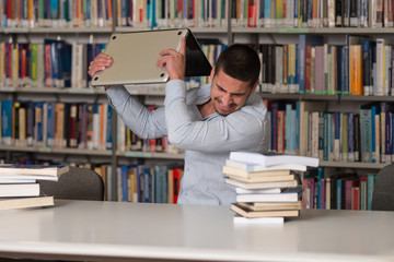 Furious Student Throwing His Laptop Away