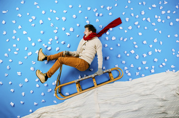 Young man on sled having fun