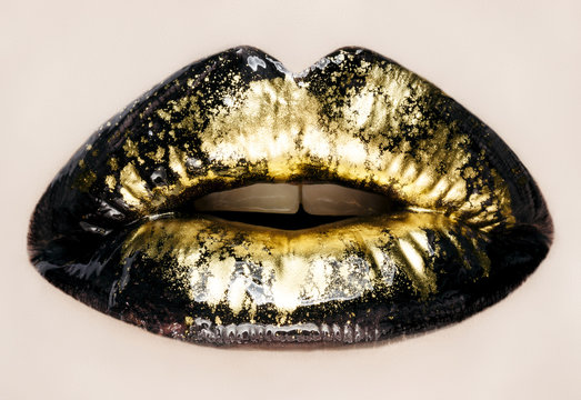 Black and gold lips close up, macro photography