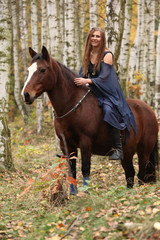 Amazing girl riding a horse without any equipment in autumn fore