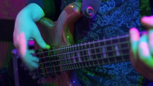 Fingers plays the bass guitar