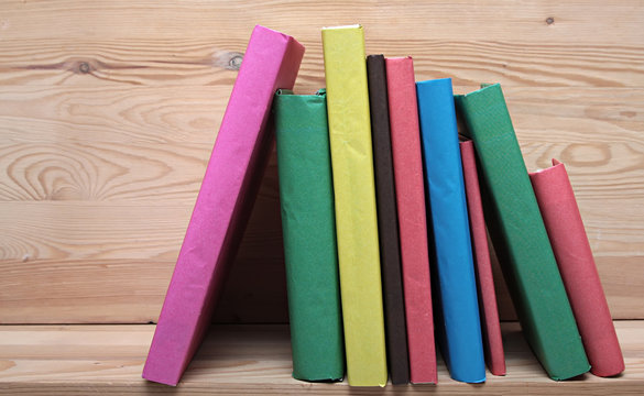 Books on wooden shelf close-up