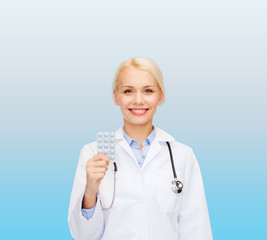 smiling female doctor with pills