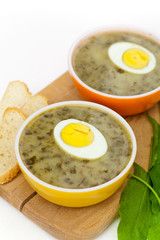 Sorrel soup with egg and greens. Selective focus.