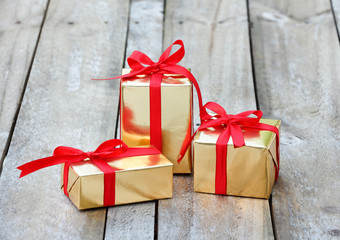gift box wrap gold paper with red ribbon