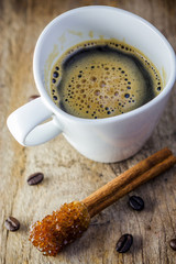 Sugar Stick Cinnamon and cup of coffee on wooden table
