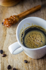 Sugar Stick Cinnamon and cup of coffee on wooden table