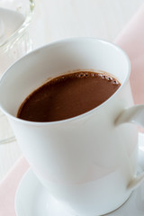 Cup of hot chocolate on a white table