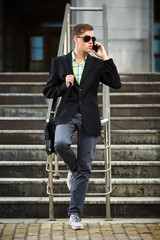 Young man calling on the mobile phone outdoor