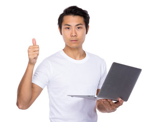 Asian man use notebook computer and thumb up