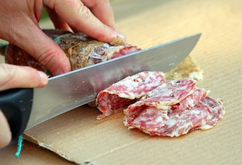 Cook cut the genuine salami