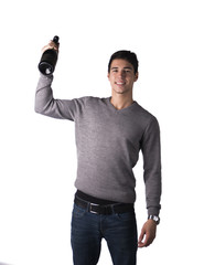 Handsome young man holding bottle of champagne