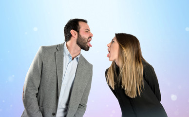 Couple sticking out her tongue over gloss background
