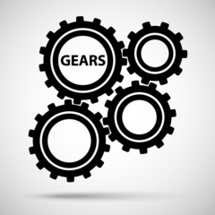 Black toothed gears (cogs) is meshed on gray background