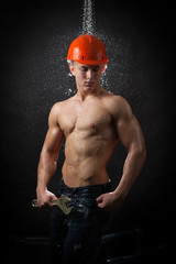 Muscular worker with a wrench 