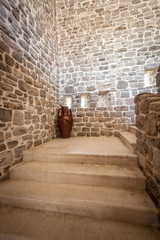 Fototapeta na wymiar long stone staircase inside of ancient tower