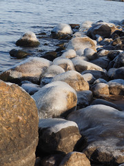 Fototapeta premium stones in the ice on the lake