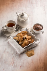 tea cup and cookie stuffed with chocolate cream