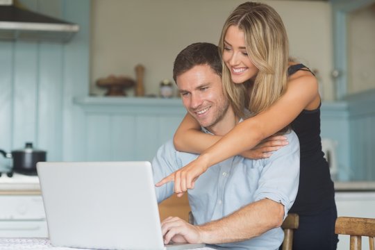 Cute couple using laptop together