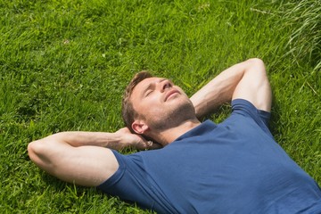 Casual man lying on the grass