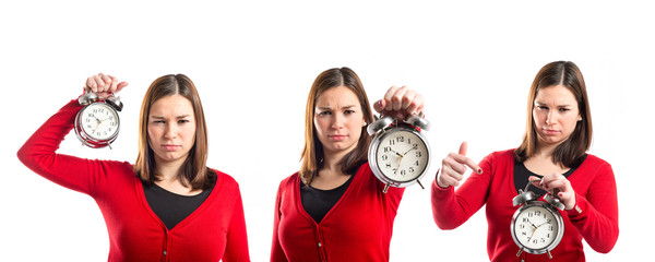 Young Girl holding an antique clock over white background