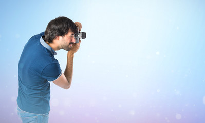 Man photographing over blue background