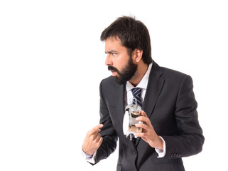 Businessman holding a clock over white background