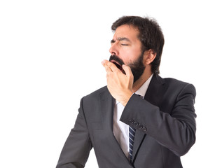 Businessman yawning over isolated white background