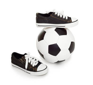 soccer ball and sport shoes on white