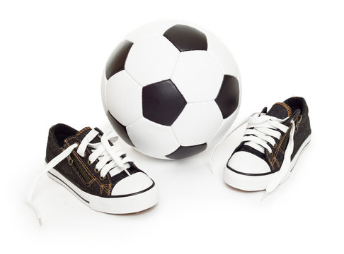 soccer ball and sport shoes on white