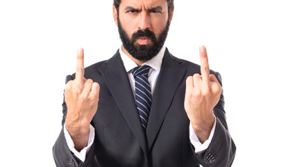 Businessman making horn gesture over white background