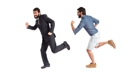 Twin brothers running fast over white background